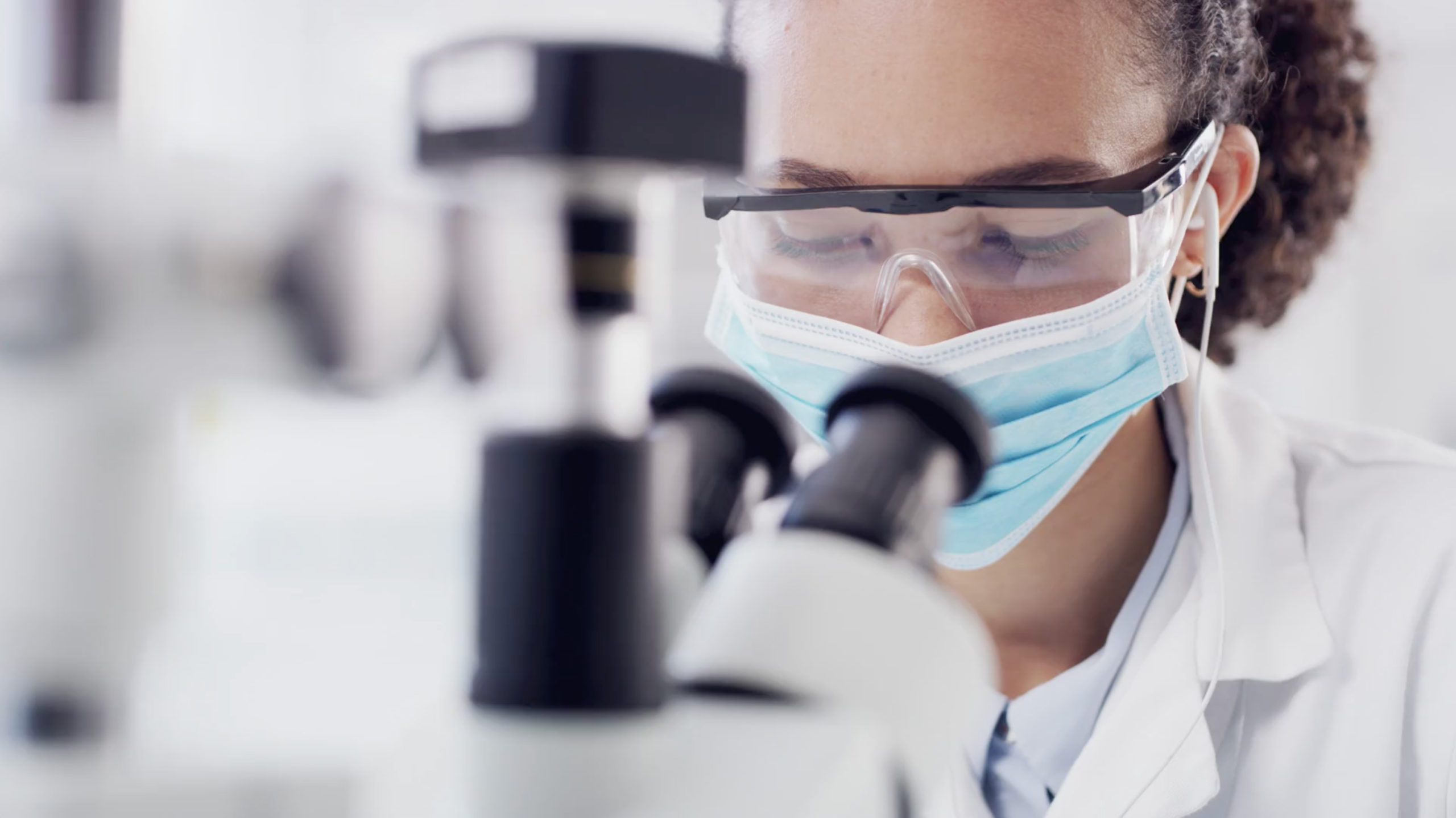 Researcher looking through microscope